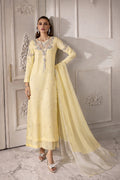 Woman wearing a light yellow embroidered traditional outfit with a white background