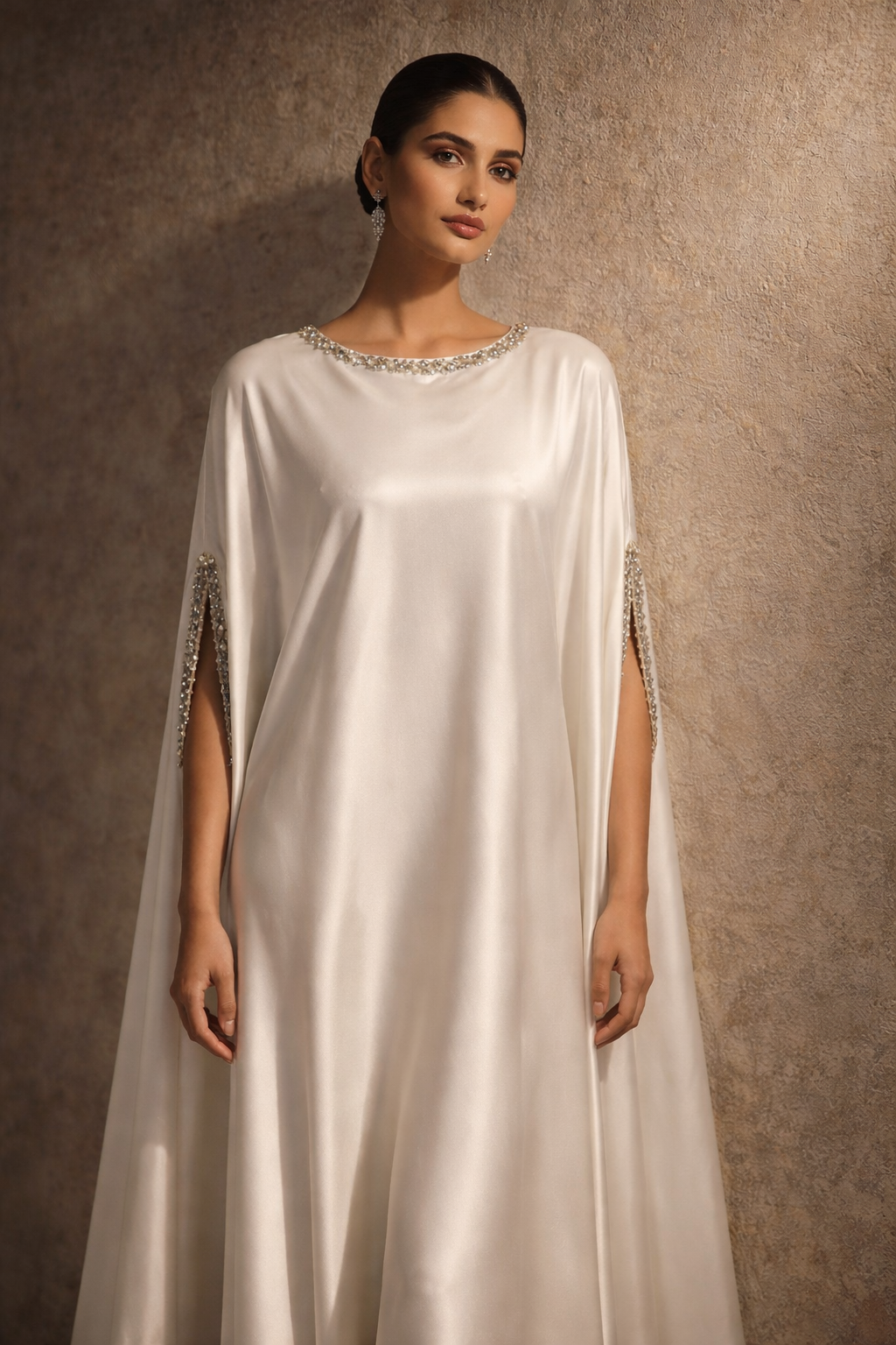 White satin kaftan with embellished neckline and flowing silhouette by Ilara London