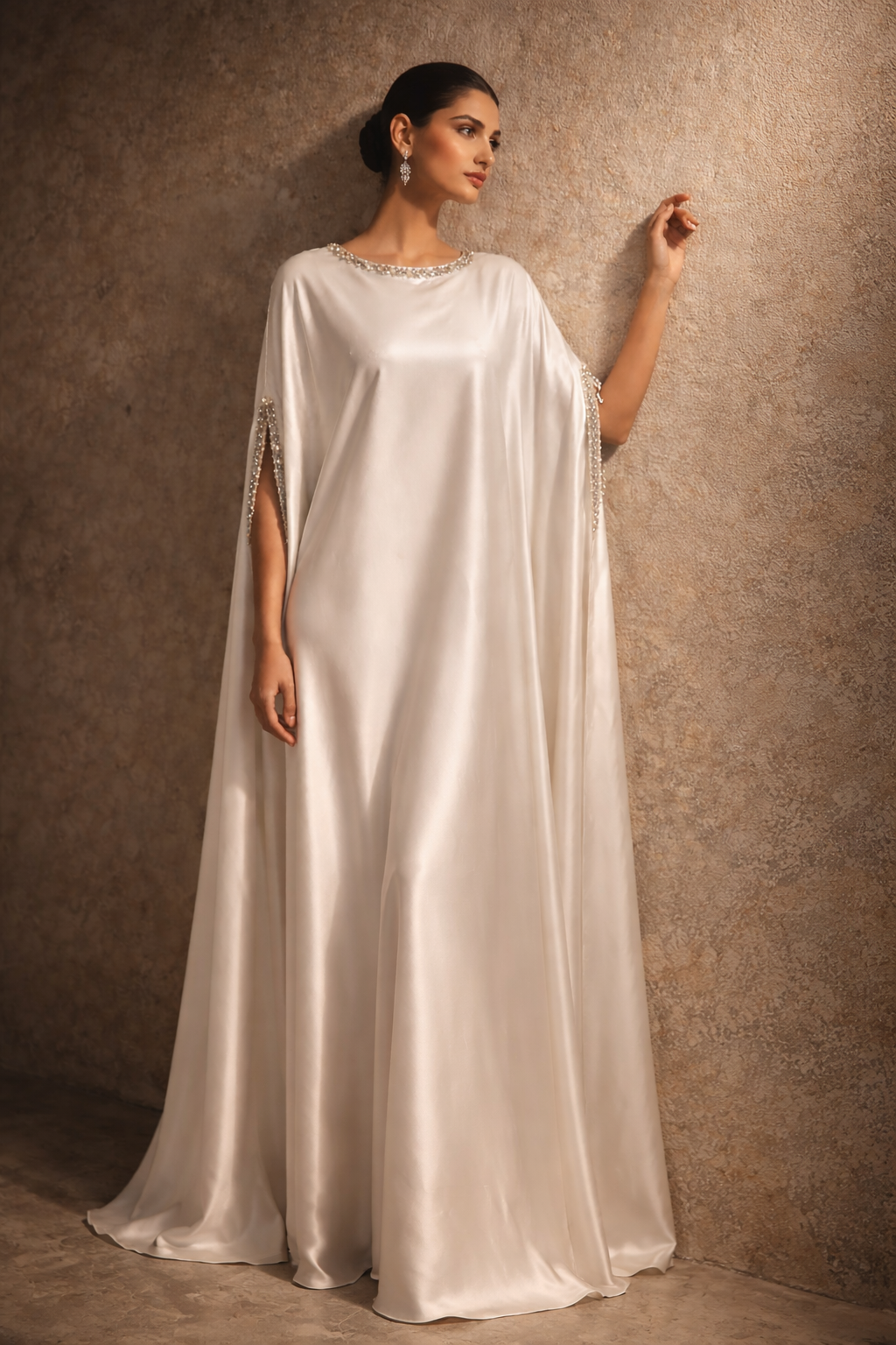 White satin kaftan with embellished neckline and flowing silhouette by Ilara London