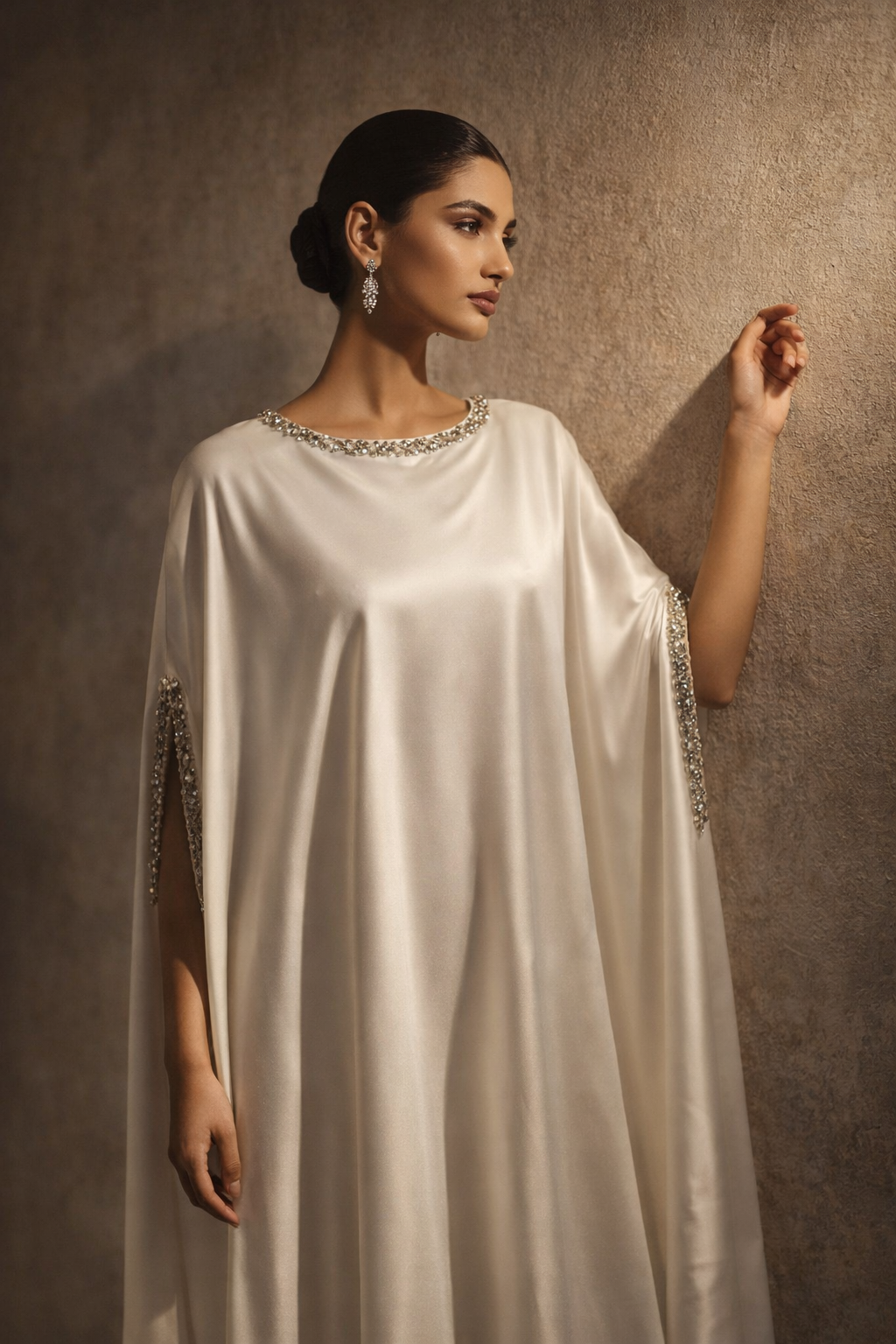 White satin kaftan with embellished neckline and flowing silhouette by Ilara London