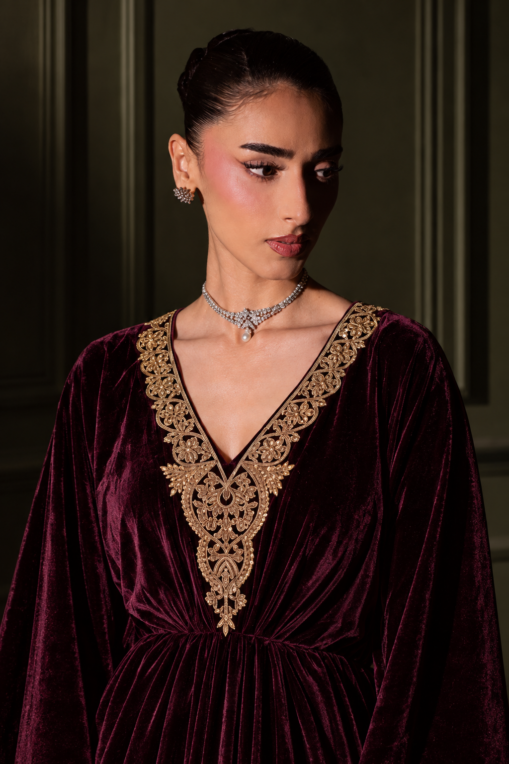 Zohra wine velvet kaftan, three-quarter view of the embroidered neckline